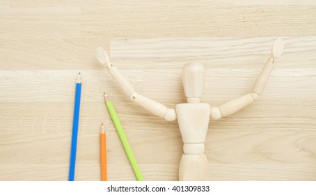 Wood doll on wooden background. Concept of art supplies, creativity and education. - Powered by Shutterstock
