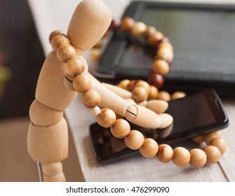 Wood doll using phone on wooden background. - Powered by Shutterstock