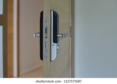 Wood door with digital door lock systems. Electronic door handle installed on wood door. Close up and selective focus. - Shutterstock ID 1157573587