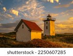 Wood End Lighthouse in Provincetown on Cape Cod, Massachusetts, USA, oceanside beach seascape at golden sunset