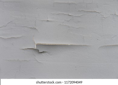 Wood Exterior House Wall With Grey Paint Cracking, Chipping And Peeling Due To Shoddy Paint Job. Properly Painting Your Home At Regular Interval Can Help Protect Against Moisture And Insect Damage.