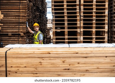 Wood factory worker man working in wood pallet distribution warehouse  - Powered by Shutterstock