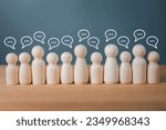 Wood figure with standing out from the crowd of different people, chatting concept, Wooden figurine with speech bubble, Unique human shape, Leadership,  Human resource.