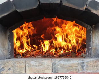 Wood Fire Burning Inside An Old Brick Oven