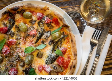 Wood Fired Oven Artisan Real Italian Pizza With Grilled Roasted Vegetable Cutlery Glass Wine Vine Top View Above