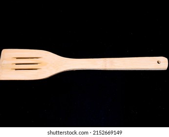Wood Flatware Kitchen Tool over a Black Background