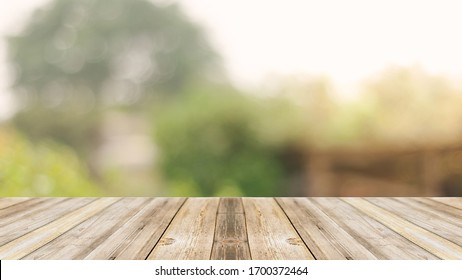 Wood floor with blurred trees of nature park background