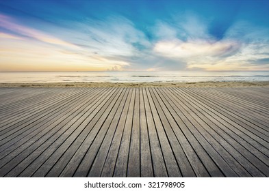 wood floor on the sea between sunrise.