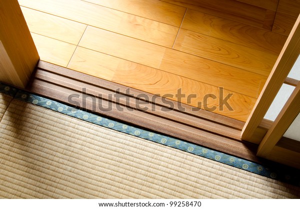 Wood\
floor and straw mat divided with paper sliding\
door