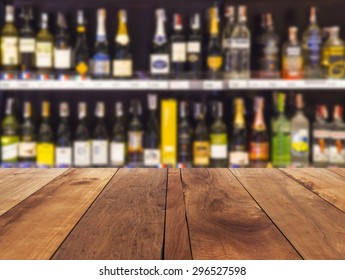 Wood Floor And Wine Liquor Bottle On Shelf - Blurred Background