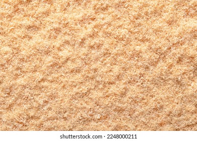 Wood flour, wood powder, fine sawdust, close-up, surface from above. Formed by sawing dried spruce. Finely pulverized wood, a by-product and waste product, mainly used as a filler and extender.