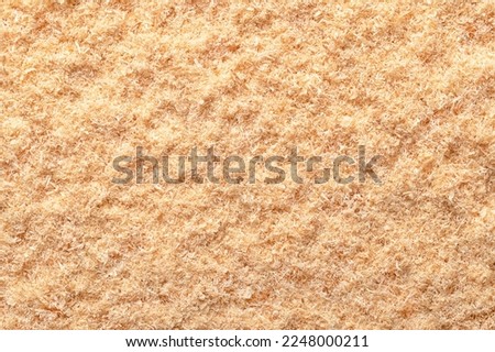 Wood flour, wood powder, fine sawdust, close-up, surface from above. Formed by sawing dried spruce. Finely pulverized wood, a by-product and waste product, mainly used as a filler and extender.