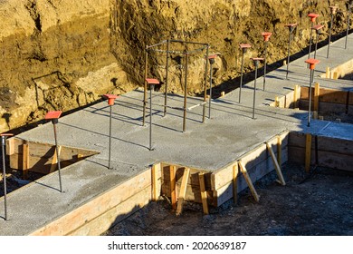 Wood Forms And Fresh Concrete Of Footings For New Commercial Building Under Construction.