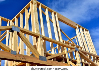 wood framework of new residential home under construction.