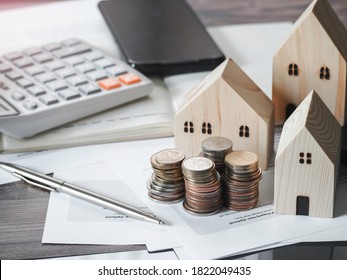 Wood house model coins money with account book finance and banking business finance concept for background. - Powered by Shutterstock