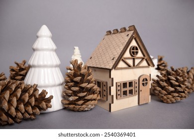 Wood house, pine cones, and white fir tree statue on a Christmas background. Perfect for rustic holiday decor and natural winter scenes - Powered by Shutterstock