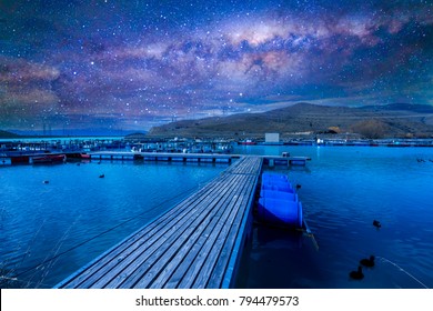 Wood jetty with milkyway background at Wairepo Arm, Twizel, New Zealand
