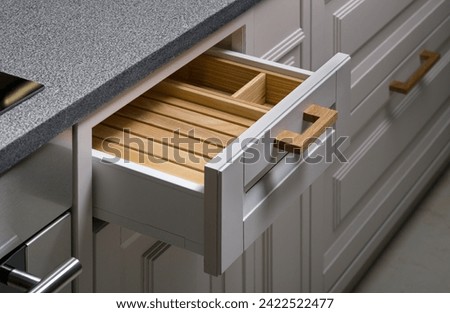 Wood kitchen or bathroom drawer organizer, utensil holder for kitchen tools, furniture details.