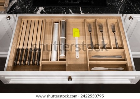 Wood kitchen drawer organizer, utensil holder with simple set of kitchen tools, furniture details.