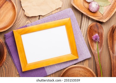 Wood Kitchen Utensils Over Wooden Table Background With Photo Frame