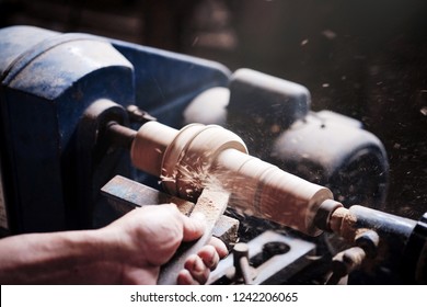 Wood lathe .Closeup hand's the Carpenter lathing wood in Thailand.The Carpenter turning wood on a lathe. - Powered by Shutterstock