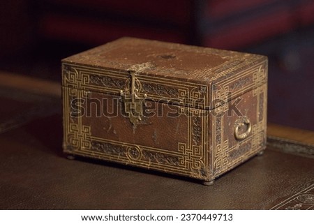 wood and leather ancient secret casket on a desk