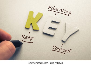 Wood letter of Key word and acronym with hand writing definition (Keep Educating Yourself)