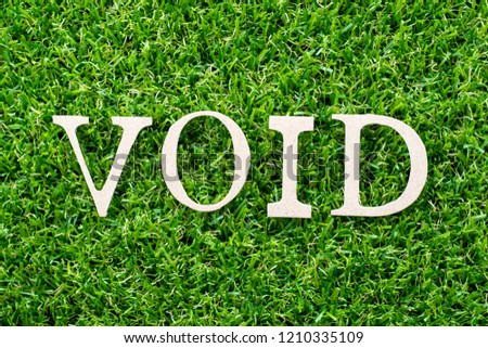 Wood letter in word void on artificial green grass background