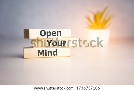 WOOD LETTERS OPEN YOUR MIND on light background.