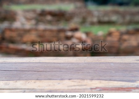Wood logs flat slide surface on blur outdoor background for realistic montage product display.
