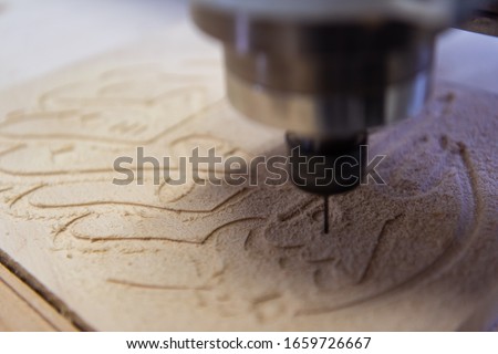wood milling on modern automatic woodworking machine with CNC. furniture production.