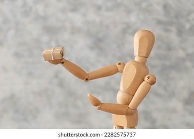 Wood model simulate receiving a package on white background. - Shutterstock ID 2282575737