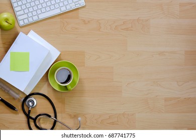 Wood Modern Doctor Desk Table With Stethoscope, Desktop Computer, Coffee Cup And Supplies.