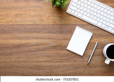 Wood Office Desk Table With Blank Notebook And Supplies. Top View With Copy Space, Flat Lay.