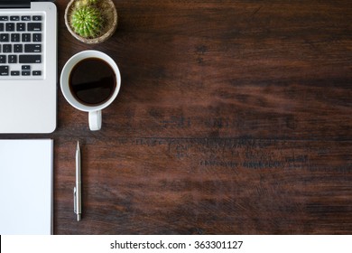 Wood Office Desk Table With Laptop, A Cup Of Coffee And Supplies. Top View With Copy Space.