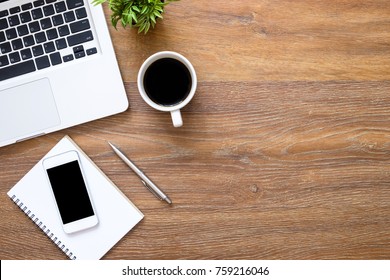 Wood Office Desk Table With Smartphone, Laptop Computer And Supplies. Top View With Copy Space, Flat Lay.