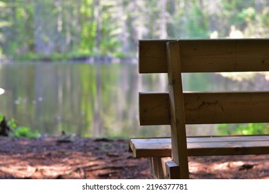 Wood Park Bench Facing Calm Lake. Solitude On Lake Side. Calm Moment.