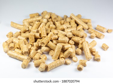 Wood pellets texture. Wooden pet bedding on white background. Close up photo.
