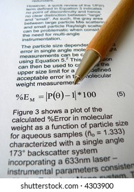 Wood Pen Lying On A Scientific Paper