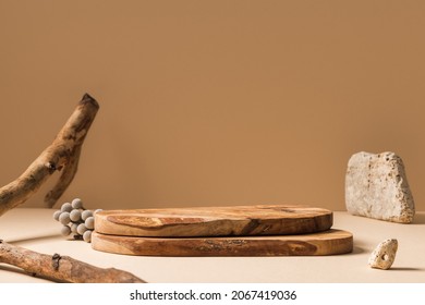 Wood pieces podium with stones and branches decorations. Background for perfume, jewellery and cosmetic products. Front view. - Shutterstock ID 2067419036