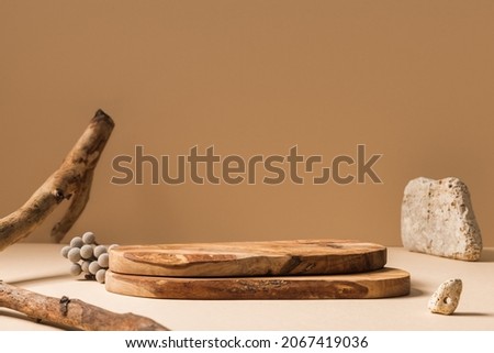 Wood pieces podium with stones and branches decorations. Background for perfume, jewellery and cosmetic products. Front view.