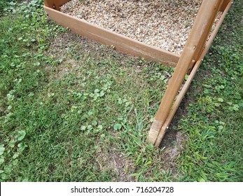 A Wood Play Structure Hit By A Lawn Mower Or Weed Wacker