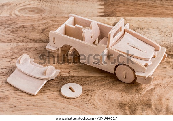Wood puzzle model car on\
wood table