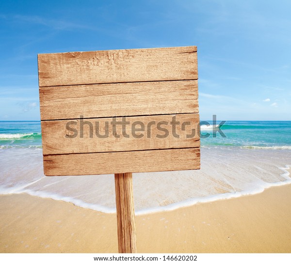 wood road sign on sea\
beach