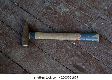 wood and rust head iron hammer lying on wooden board with outdoor workshop. High quality photo - Shutterstock ID 2005781879
