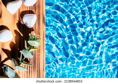 Wood Sand Board With Hot White Salt Stones And Twig Natural Eucalyptus. Blue Transparent Reflect Wave Water Surface Ocean. Hot Warm Stone Massage Therapy Treatment Concept. Right Place For Text.