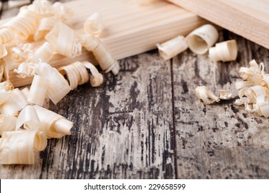 Wood shavings o0n a wooden background