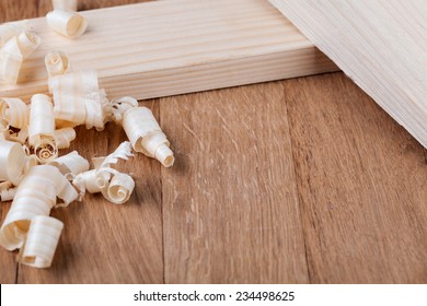 Wood shavings o0n a wooden background