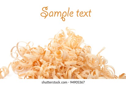 Wood shavings on white background with copy space. Macro with shallow dof.
