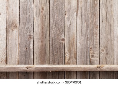 Wood Shelf In Front Of Wooden Wall. View With Copy Space